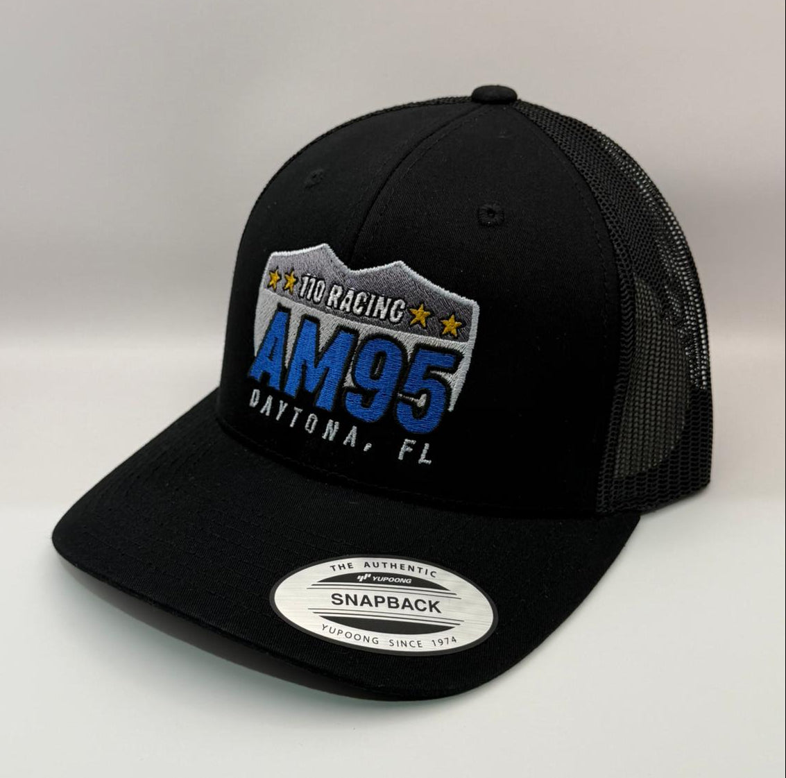 Black trucker cap with AM95 logo on a white background