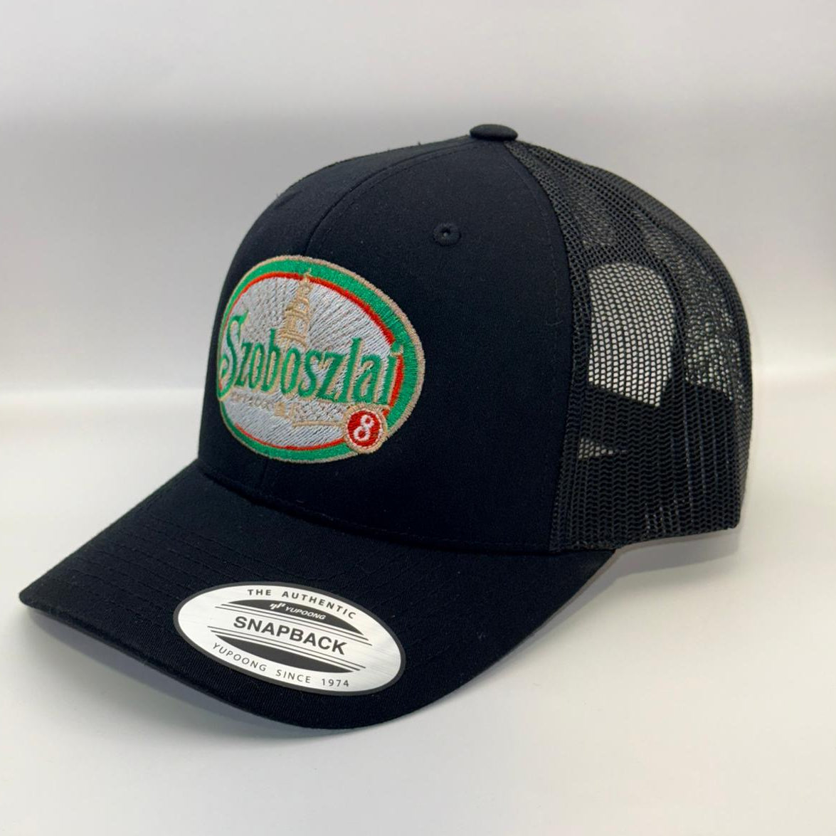 Black trucker cap with a brand logo on a white background