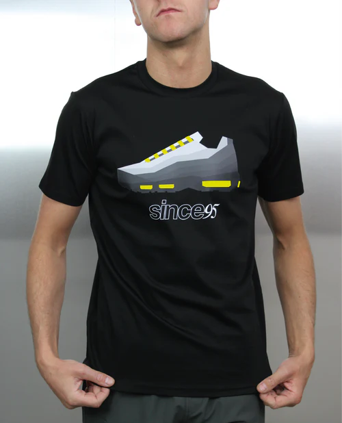 Person wearing a black t-shirt with a graphic of a sneaker and 'since95' text.