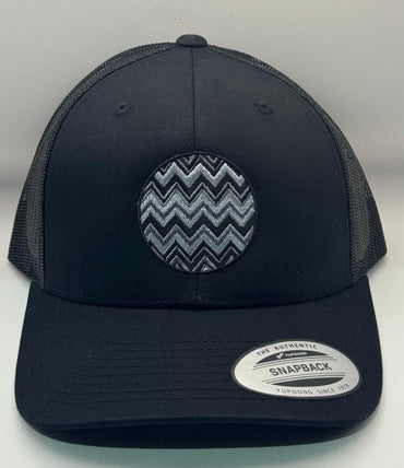 Black trucker cap with a zigzag pattern on a white background