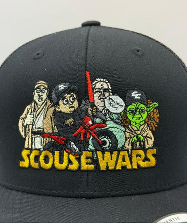 Black cap with embroidered characters and 'SCOUSE WARS' text on a plain background