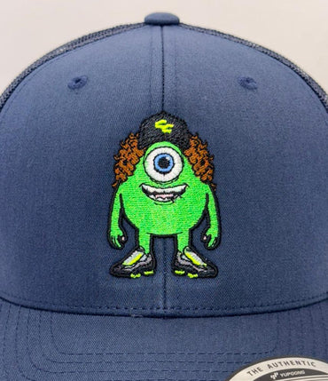 Blue snapback cap with a green character design on a white background