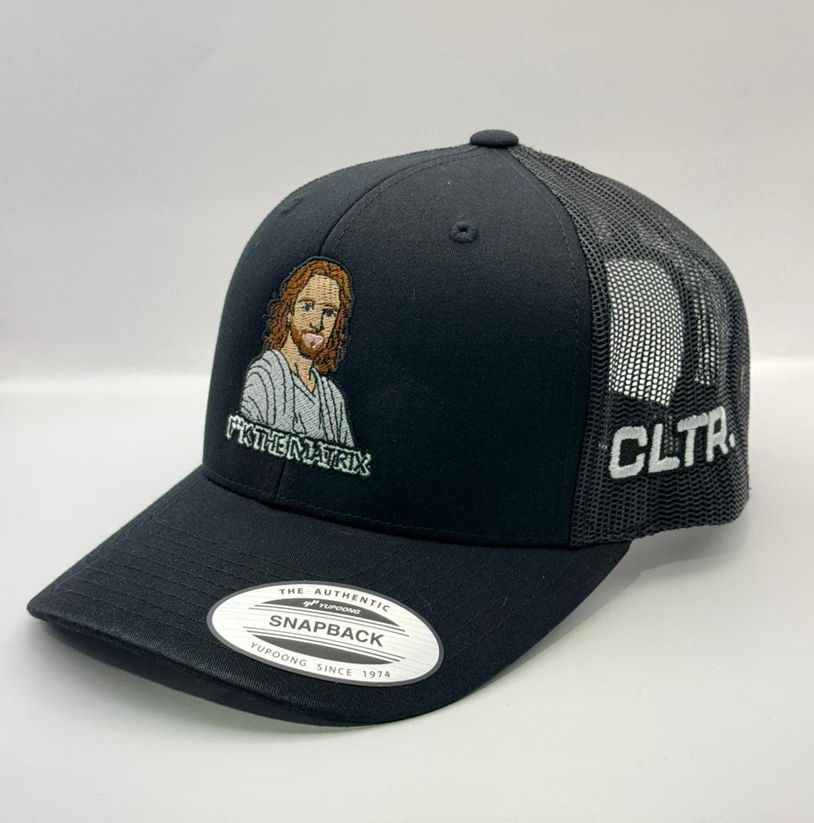 Black cap with embroidered design and text on a white background