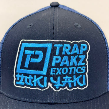 Navy blue cap with blue and white branding on a beige background