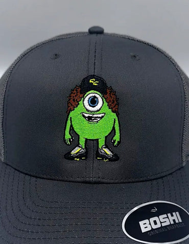 grey cap with a green mike alien design on a gray background