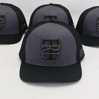 Four black and gray caps with a logo on a white background
