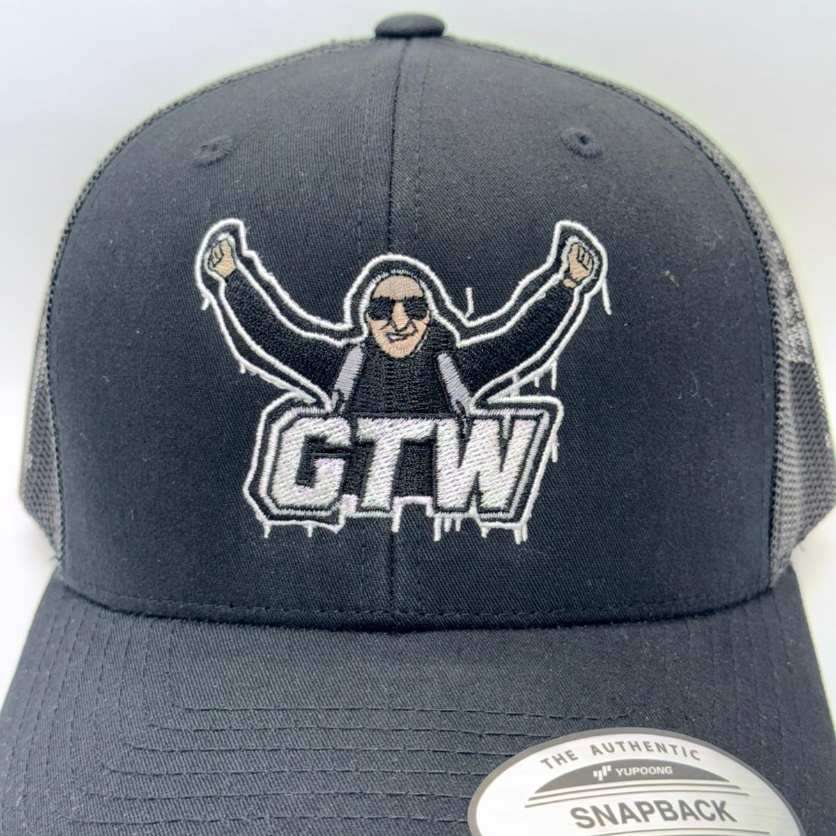 Gray snapback cap with embroidered design and 'GTW' logo on a white background