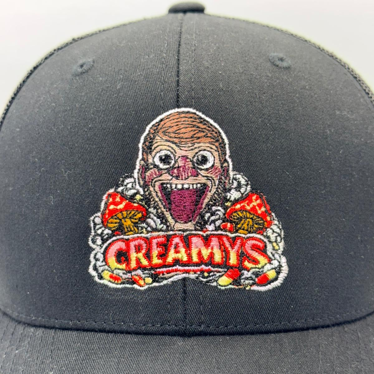 Gray cap with a colorful 'Creamy's' logo on a white background