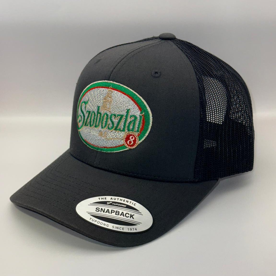 Black trucker cap with a brand logo on a white background