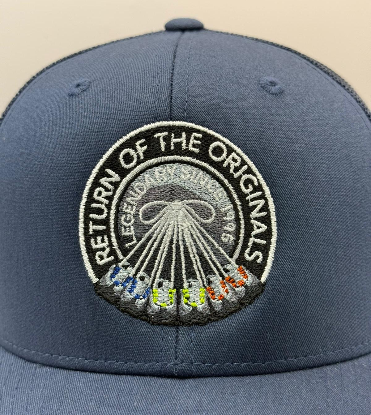 a navy cap with airmax 95 neon mandarin and spark blue trainers
