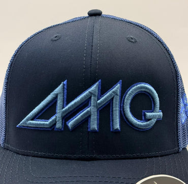 Navy blue cap with blue mesh and embroidered logo on a beige background