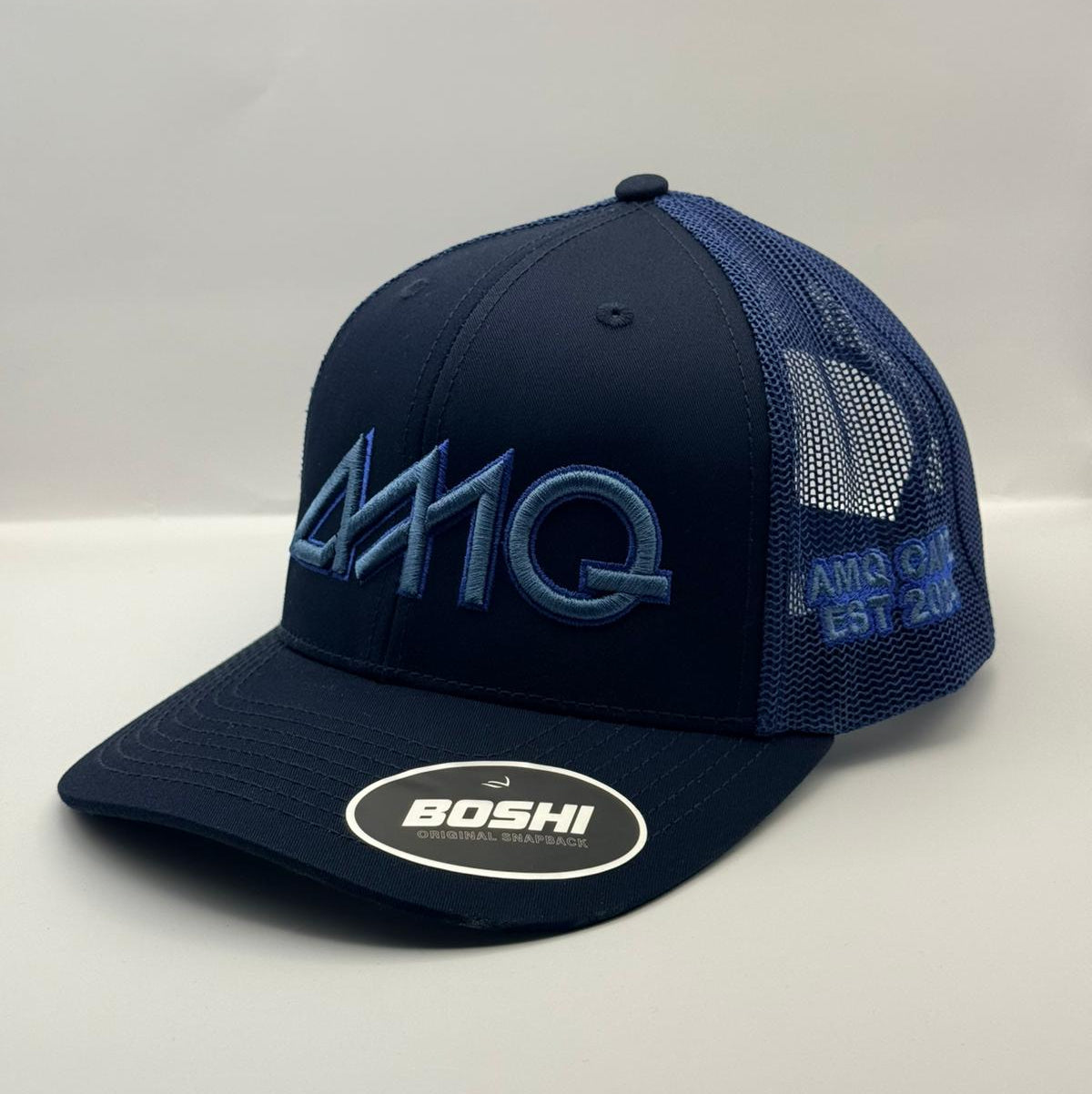 Navy blue cap with mesh back and embroidered logo on a white background