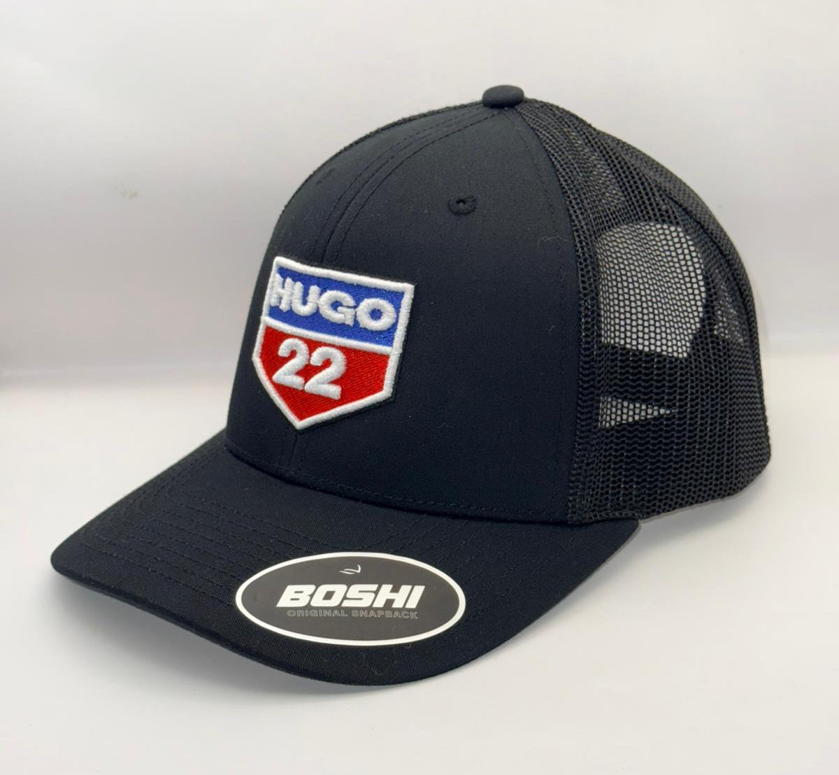 Black trucker cap with a logo and text on a white background
