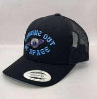 Black trucker cap with 'Dreaming Out of Space' logo on a white background