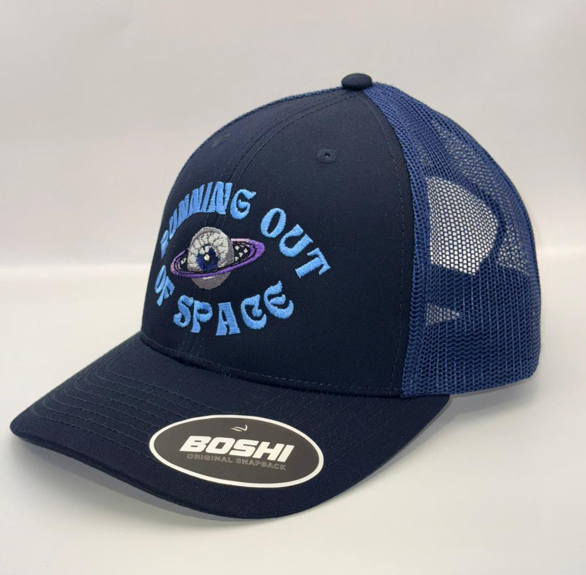 Navy blue cap with mesh back and 'Running Out of Space' text on a white background
