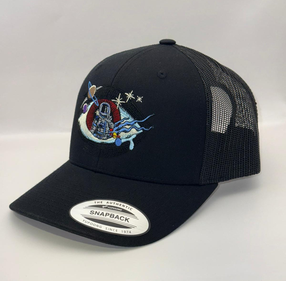 Black trucker cap with colorful design on a white background