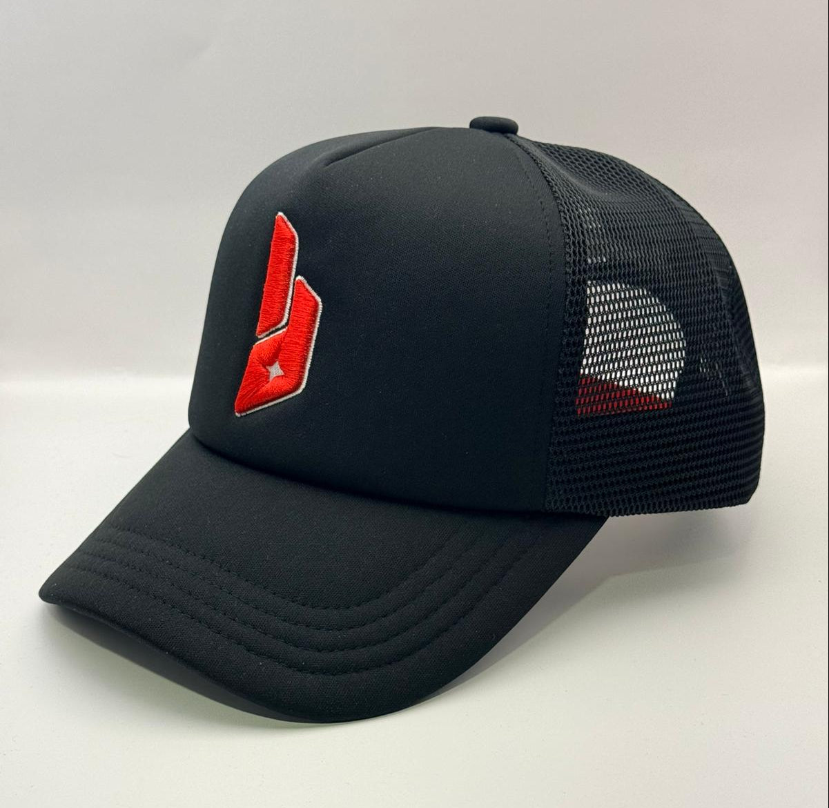 Black trucker cap with a red logo on a white background