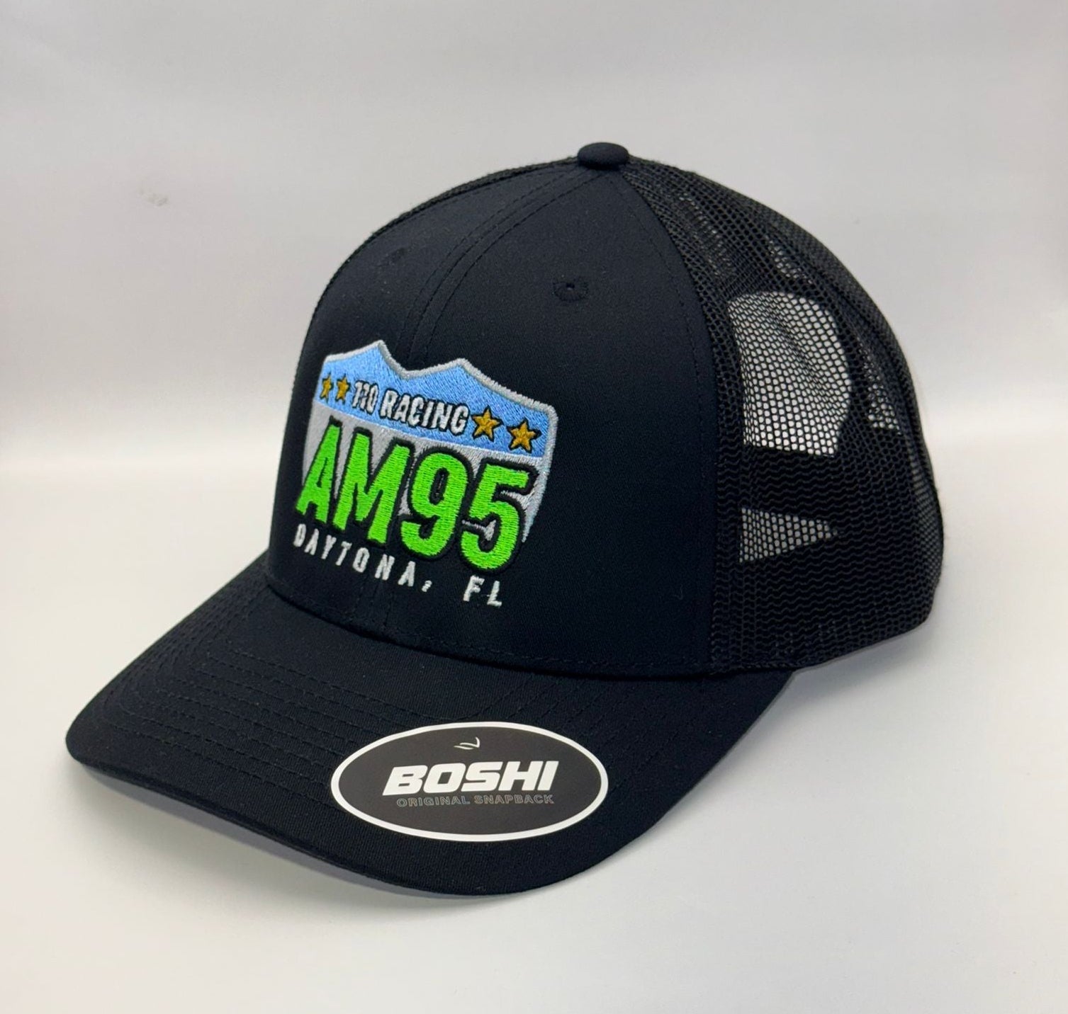 Black trucker cap with AM95 Daytona, FL logo on a white background