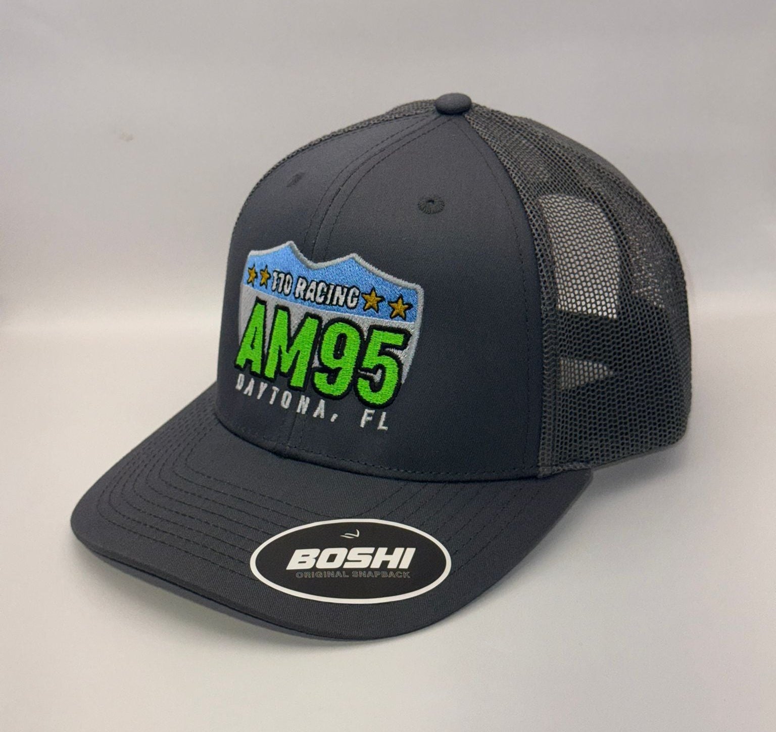Black mesh cap with AM95 branding on a white background