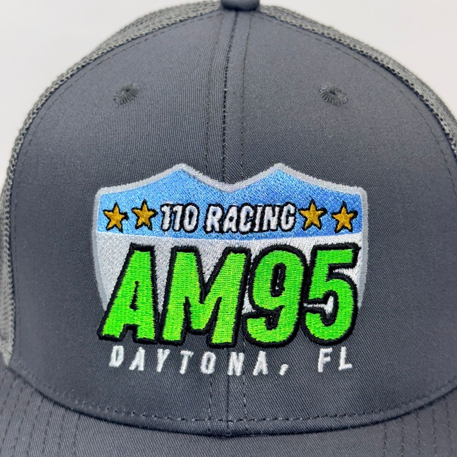Gray cap with '110 Racing AM95 Daytona, FL' logo on a white background