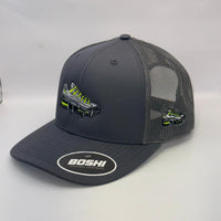 Gray trucker hat with mesh back and embroidered logo on a white surface