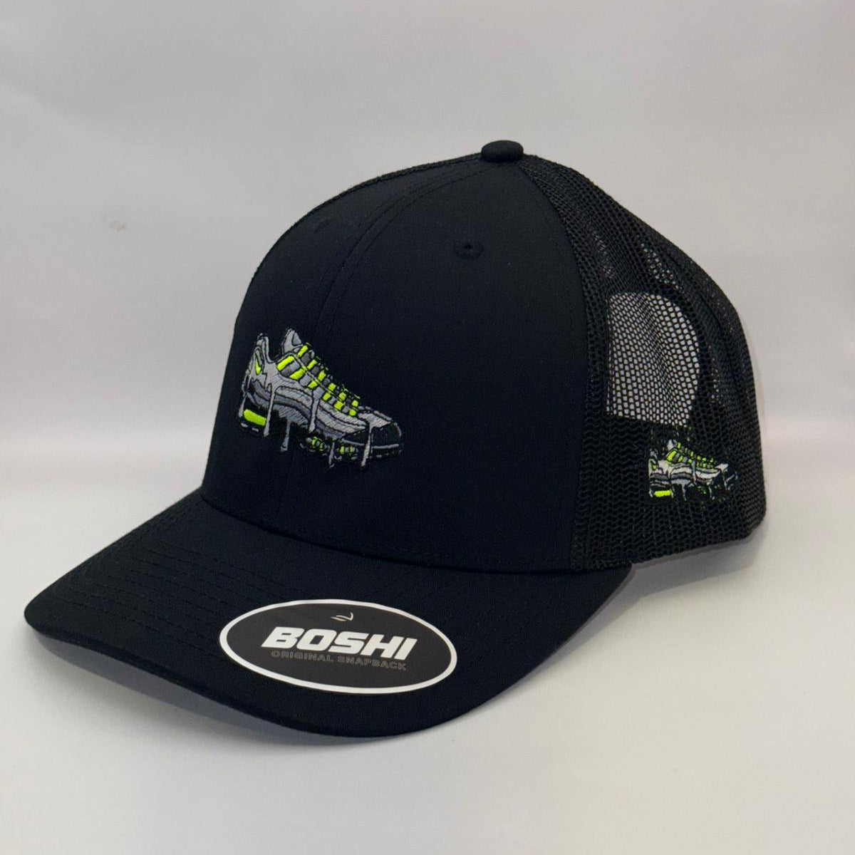 Black trucker cap with embroidered design and 'BOSHI' logo on a white background