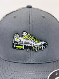 Gray cap with embroidered shoes design on a light gray background