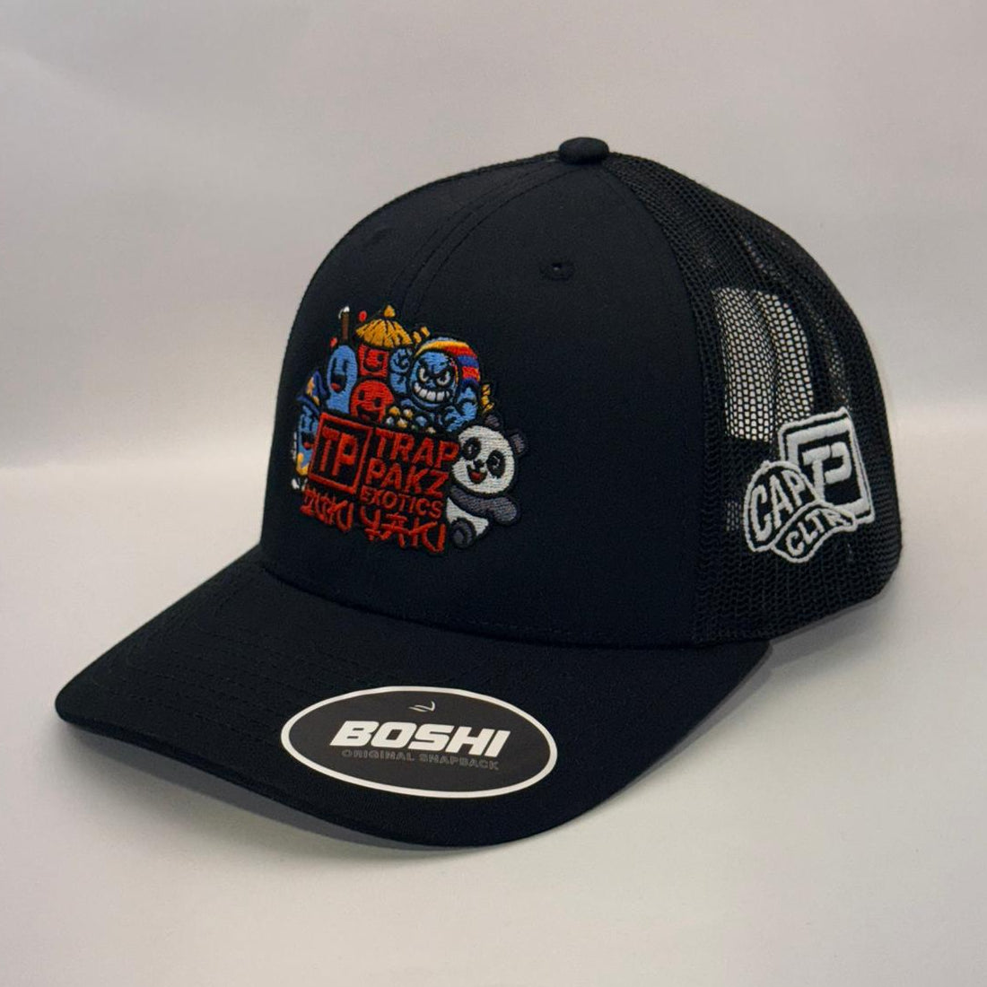 Black cap with colorful designs and brand logos on a white background