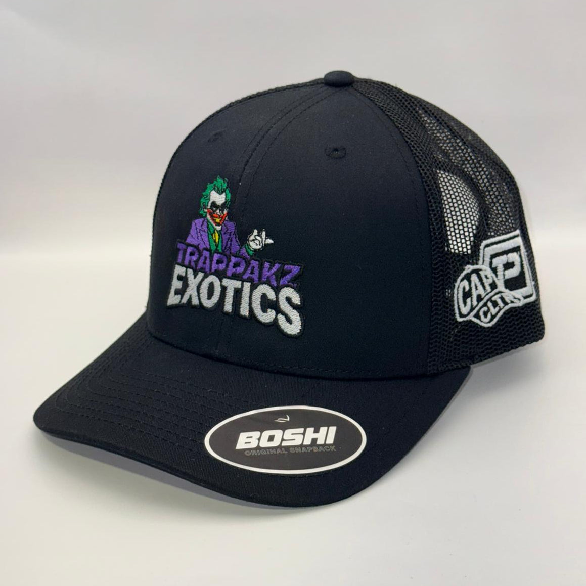 Black cap with multiple brand logos on a white background