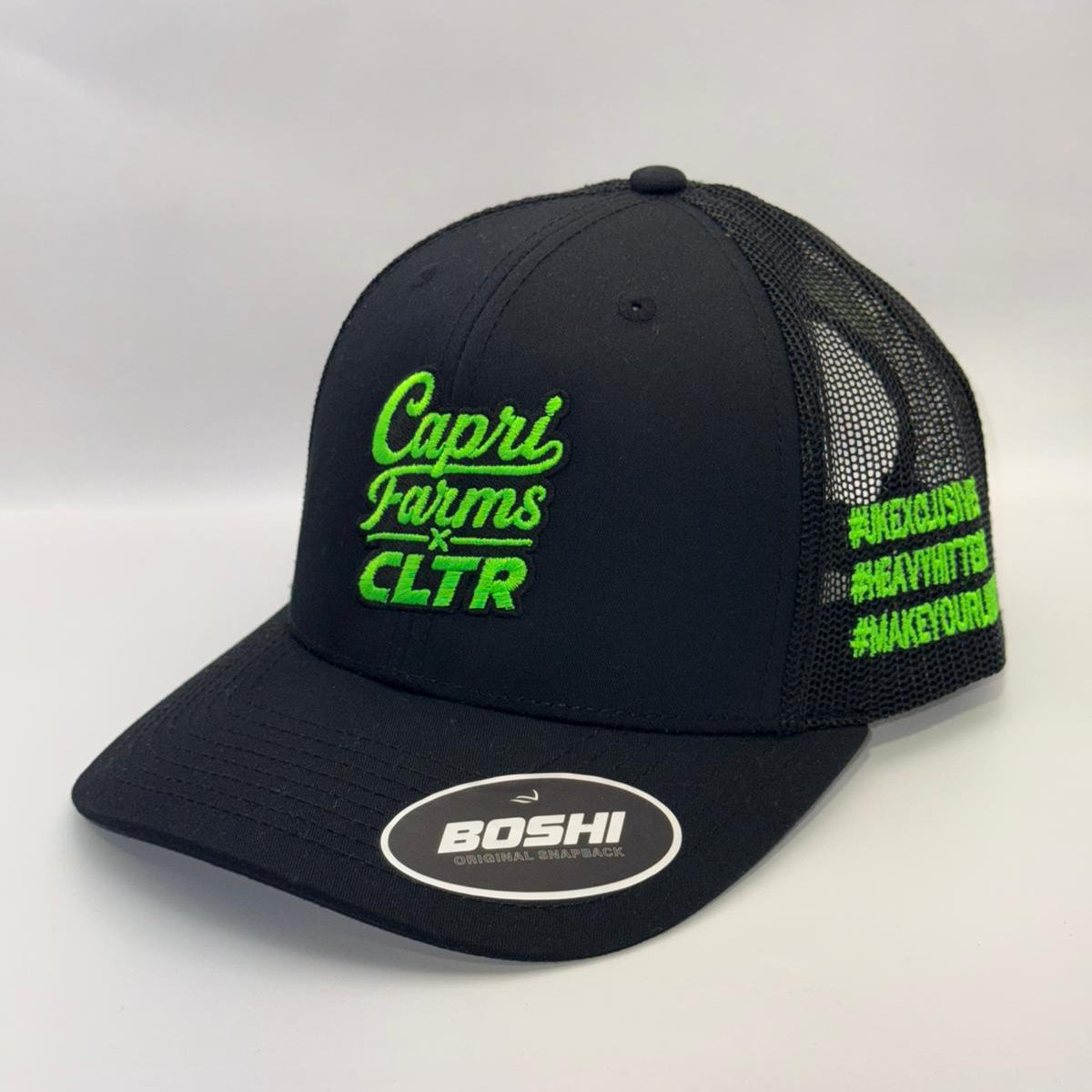 Black cap with green text and branding on a white background