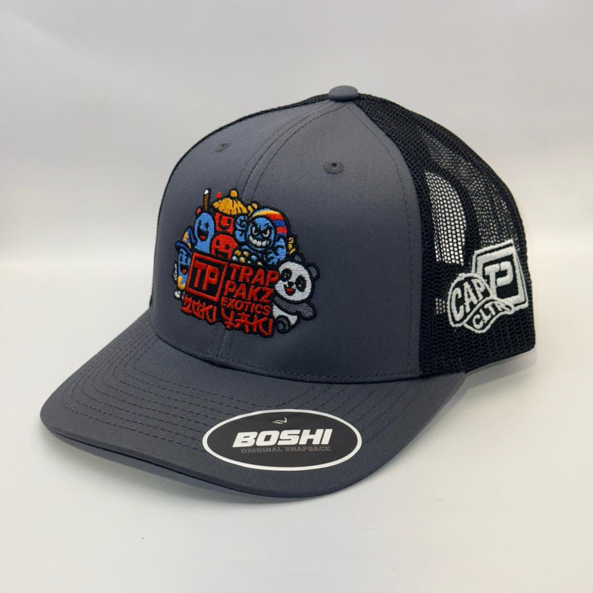 Gray and black cap with colorful graphics and brand logos on a white background