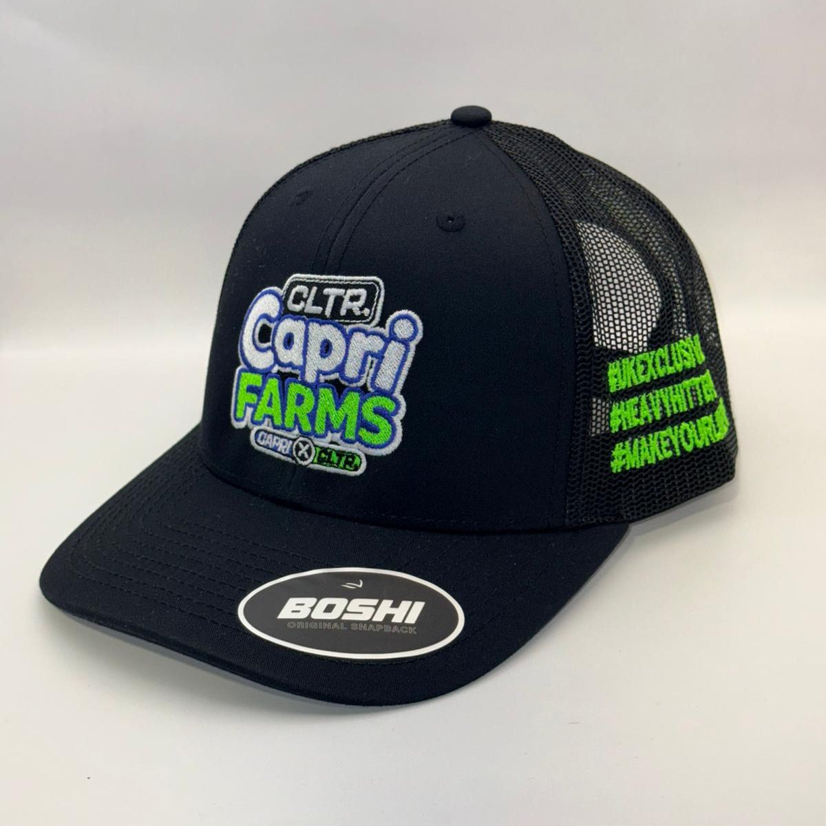 Black cap with green and white text on a white background