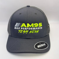A dark gray trucker-style cap with mesh back panels, featuring 'AM95 MAX PERFORMANCE TEAM NEON' embroidered on the front in yellow and white, and a 'BOSHI' sticker on the brim.
