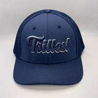 A navy blue trucker-style baseball cap with a curved brim and mesh back panels, featuring the word 'Trilfest' embroidered in metallic silver script across the front.