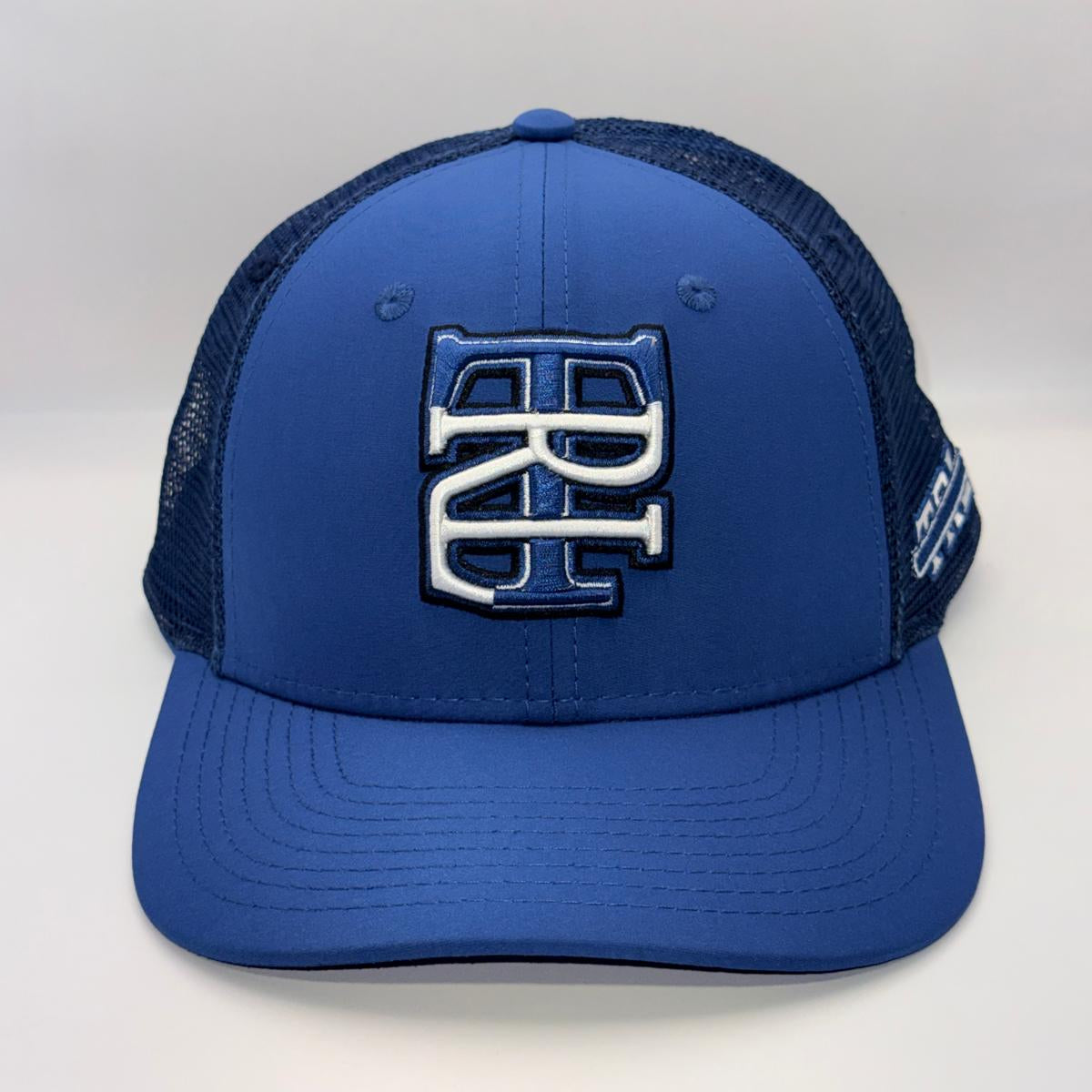A royal blue trucker hat with a structured front panel and dark navy mesh back. The front features a large, raised interlocking 'BC' logo in navy and white.