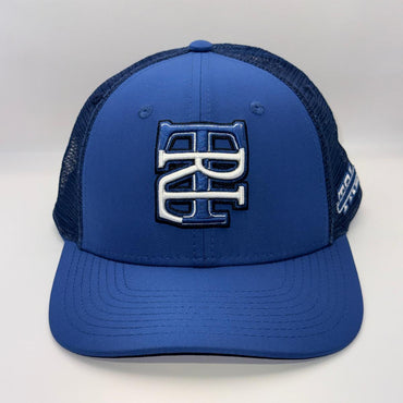 A royal blue trucker hat with a structured front panel and dark navy mesh back. The front features a large, raised interlocking 'BC' logo in navy and white.
