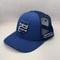 A royal blue trucker cap with a curved brim, featuring a blue front panel with a white and blue embroidered 'BC' logo, and a dark blue mesh back. A white 'MCI TIRE' logo is visible on the side mesh.