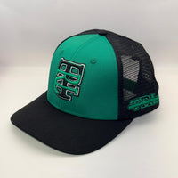 A green and black trucker-style baseball cap with a curved brim, featuring a green front panel with a black and green embroidered 'BB' logo, black mesh back panels, and green branding on the side.
