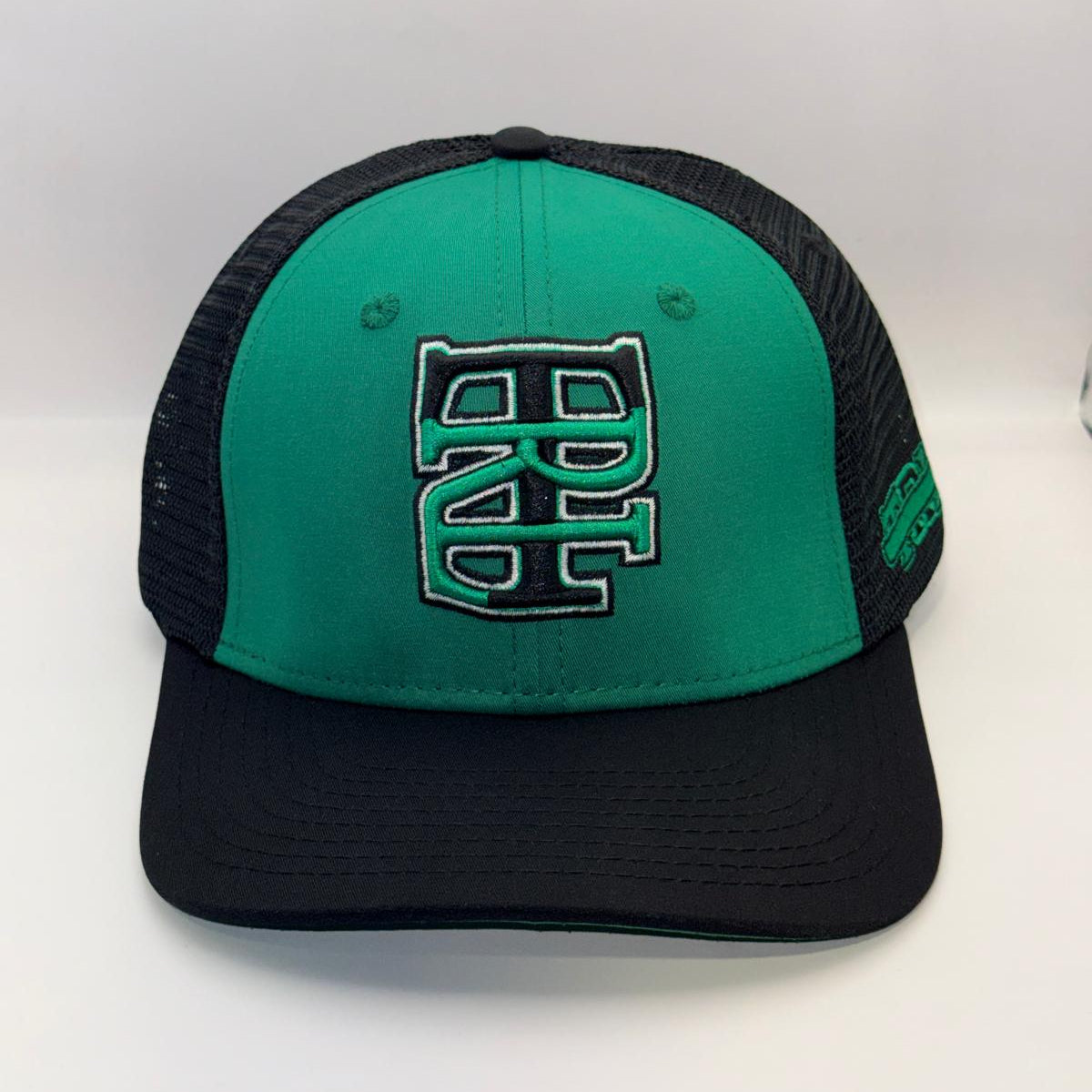 A green and black trucker-style baseball cap with a large embroidered 'BC' logo on the front, set against a plain white background.