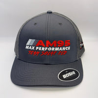 A dark gray mesh-back trucker cap with a curved brim, featuring 'AM95 MAX PERFORMANCE TEAM SOLAR RED' embroidered on the front in red and white, and a circular 'BOSHI' sticker on the brim.