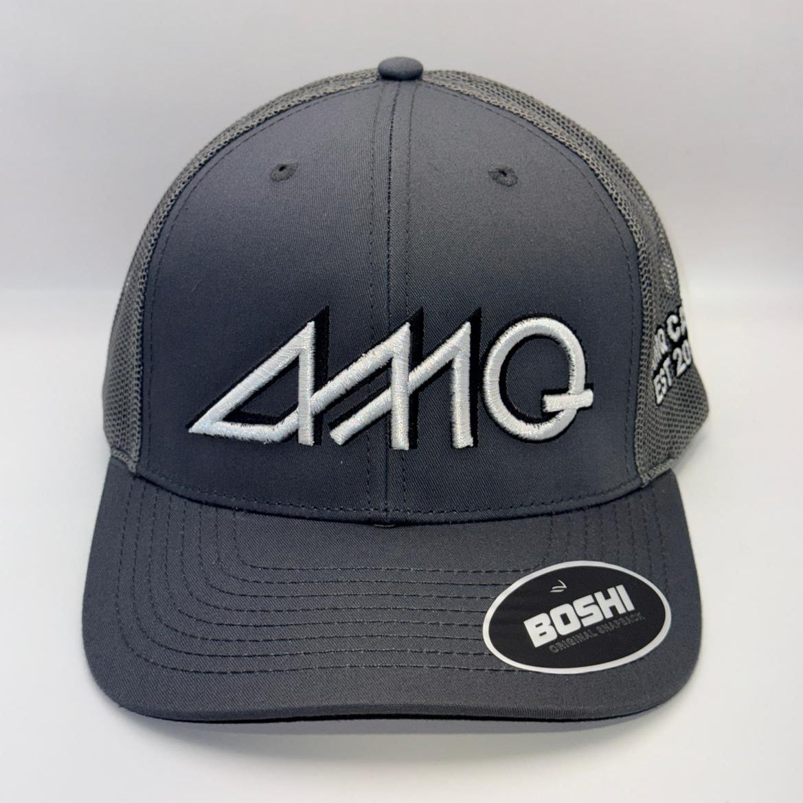 A dark gray and black trucker hat with a white embroidered '444Q' logo on the front and a 'BOSHI' sticker on the brim, set against a plain light gray background.