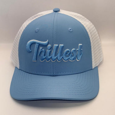 A light blue and white trucker hat with 'Trillest' embroidered in light blue script on the front, set against a neutral light gray background.