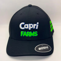 A black trucker-style baseball cap with 'Capri FARMS' embroidered on the front in white and neon green, featuring a visible BOSHI logo sticker on the brim and green embroidery on the side mesh.