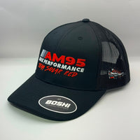 A black mesh-back trucker hat with a curved brim, featuring 'AM95 MX PERFORMANCE' and 'TEAM SOLAR RED' embroidered on the front in red and white, with a circular 'BOSHI' sticker on the brim.
