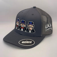 A dark gray and black mesh-back trucker hat featuring a cartoon graphic of three men in top hats on the front, a 'CART CARTEL' logo on the side, and a 'BOSHI' sticker on the visor.