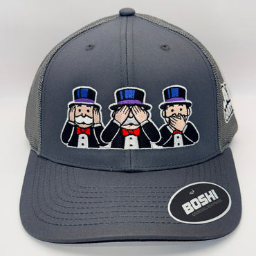A dark gray trucker hat with a mesh back, featuring an embroidered patch of three Monopoly-style figures in black tuxedos and top hats on the front. A circular black and white 'BOSHI' sticker is on the brim.