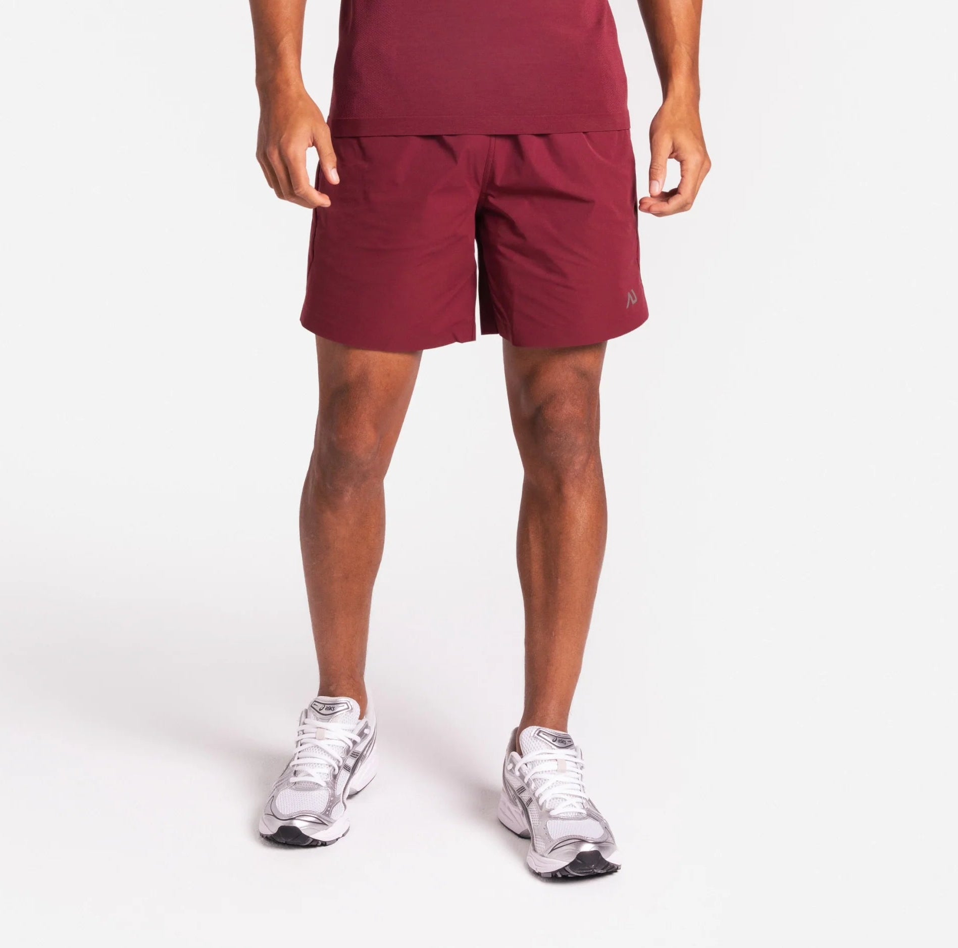 Person wearing a maroon and pink gradient outfit on a white background