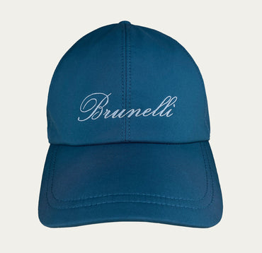 Blue cap with 'Brunelli' branding on a light gray background